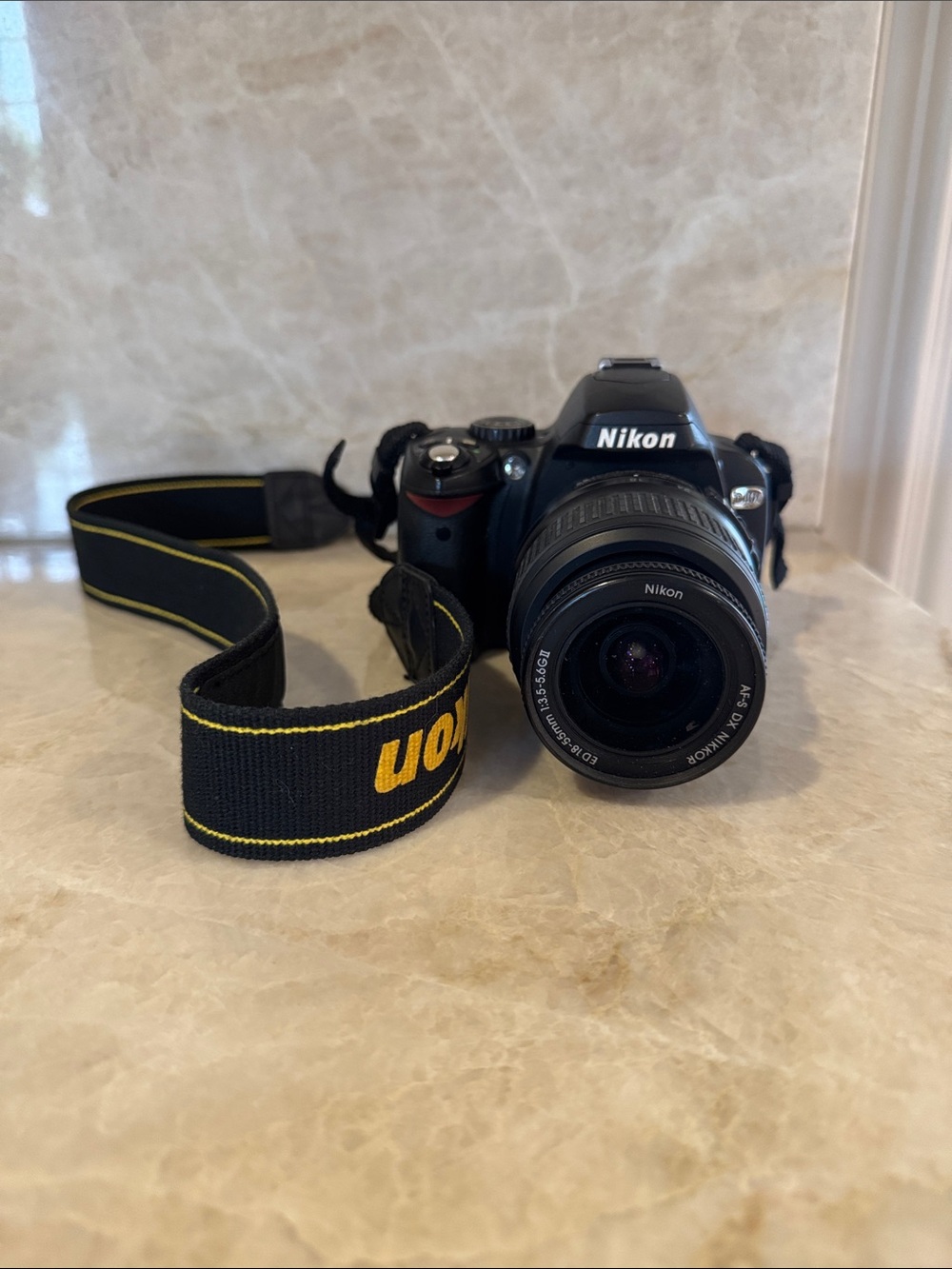 Nikon Black DSLR with Black and Yellow Branded Strap